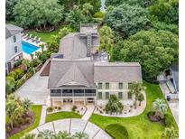Expansive home boasts a pool, rooftop deck, well-manicured lawn, and mature landscaping at 994 Debordieu Blvd., Georgetown, SC 29440