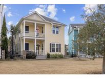 Charming yellow two-story home with double porches and a well-maintained lawn at 1188 Peterson St., Myrtle Beach, SC 29577