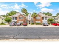 Inviting brick building complex showcasing mature landscaping, parking and classic architectural charm at 120 Brentwood Dr. # E, Murrells Inlet, SC 29576