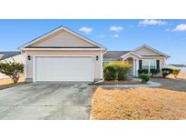 Charming single-story home with a two-car garage and well-maintained front yard with mature landscaping at 1220 Dunraven Ct., Conway, SC 29527