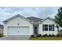 Charming single-story home featuring a one-car garage, neutral siding and a well-manicured lawn at 148 Leyland Cypress Dr, Conway, SC 29527