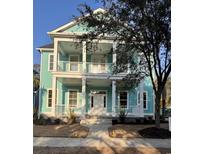 Charming two-story light blue home with double front porch and white pillars at 1517 James Island Ave., North Myrtle Beach, SC 29582