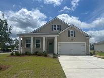 Charming single-Gathering home featuring a welcoming front porch and a two-car garage at 152 Leyland Cypress Dr, Conway, SC 29527