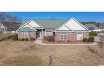Charming brick home featuring a manicured front yard with mature landscaping at 153 Highmeadow Ln., Aynor, SC 29511