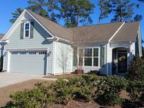 Charming single-story home with a well-manicured lawn, a gray garage door, and lovely landscaping at 1883 Suncrest Dr., Myrtle Beach, SC 29577
