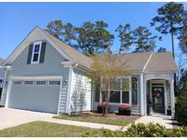 Charming single-Gathering home showcasing a neat lawn, attached garage, and welcoming front porch at 1883 Suncrest Dr., Myrtle Beach, SC 29577