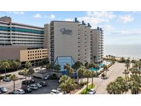 A picturesque view of Carolina Winds resort, showcasing its pool, palm trees, and proximity to the beach at 200 76Th Ave. N # 510, Myrtle Beach, SC 29572