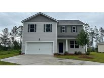 Two-story home features a two-car garage, gray siding and black shutters at 210 Bald Cypress Way, Conway, SC 29527