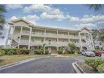 Inviting three-story condo building featuring multiple balconies and attractive landscaping at 4179 Hibiscus Dr. # 303, Little River, SC 29566