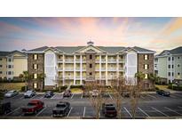 Stunning condo with a beautiful facade, multiple balconies, a well-maintained parking area, and gorgeous sunset views at 4865 Luster Leaf Circle # 304, Myrtle Beach, SC 29577