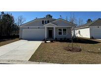 Charming single-Gathering home featuring a two-car garage and well-manicured lawn and neutral siding at 5012 Neverland Ct, Myrtle Beach, SC 29588
