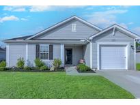 Charming single-story home with well-maintained lawn and inviting curb appeal at 693 Landmark Cove Rd., Carolina Shores, NC 28467