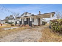 Charming single-Gathering home with a covered driveway and black-and-white accents at 708 Bobby L. Davis Blvd., Marion, SC 29571