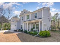 Charming two-story home with a well-manicured lawn and inviting front porch at 818 Mourning Dove Dr., Myrtle Beach, SC 29577