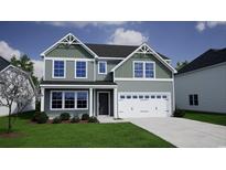 Charming two-story home boasts eye-catching architecture, a two-car garage, and a well-manicured front lawn at 911 Agostino Dr., Myrtle Beach, SC 29579