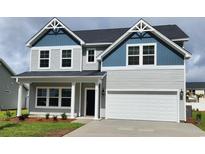 Charming two-story home with grey siding, blue accents, and a well-manicured front yard at 911 Agostino Dr., Myrtle Beach, SC 29579