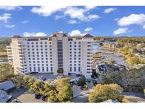 Stunning aerial view of the condo building with manicured landscaping, parking, and waterfront views at 9547 Edgerton Dr. # Ph1005, Myrtle Beach, SC 29572