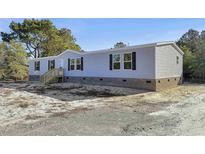 Charming single-story home features gray siding, brick foundation, and black shutters at 1455 Francis Marion Dr., Georgetown, SC 29440