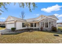 Charming single story home with a brick and white exterior, attached garage, and landscaped front yard at 1021 Dunraven Ct., Conway, SC 29527