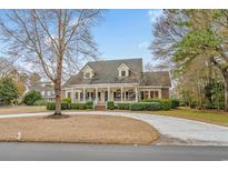 Charming traditional home featuring a welcoming front porch and a circular driveway at 1110 Links Rd., Myrtle Beach, SC 29575