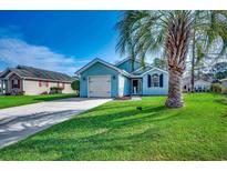 Charming blue single-story home featuring a well-maintained front yard with a classic white garage door at 1205 Formby Ct., Myrtle Beach, SC 29588