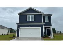 Two-story navy home featuring a two-car garage, contrasting white trim and dark shuttered windows at 144 Leyland Cypress Dr, Conway, SC 29527