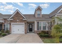 Charming home with stone accents, a one-car garage, and a well-maintained lawn in a desirable community at 156 Parmelee Dr. # B, Murrells Inlet, SC 29576