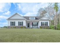 Charming single-story home with a well-manicured lawn, black shutters, and an inviting front porch at 250 Ole Maple St., Loris, SC 29569