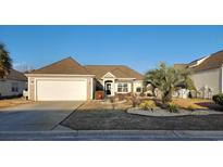 Charming single-story home featuring manicured landscaping, a two-car garage, and a welcoming entrance at 3108 Robins Nest Way, Myrtle Beach, SC 29579