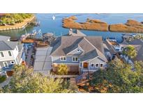 Stunning aerial view of a two-story home with a boat dock and water access at 3567 Marion Ln., Murrells Inlet, SC 29576