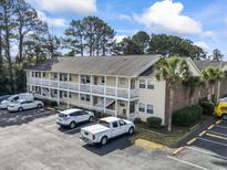 Inviting condo building with parking, offering comfortable living and community charm at 4150 Horseshoe Rd. # 5, Little River, SC 29566