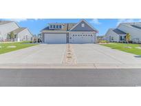 Charming two-story home featuring double garages and pristine landscaping for enhanced curb appeal at 559 Courtridge Loop, Conway, SC 29526