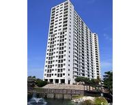 Stunning exterior shot of a high-rise condominium with private balconies, lush landscaping, and water feature at 5905 S Kings Hwy. # 1801-C, Myrtle Beach, SC 29575