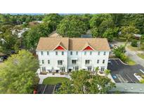 Stunning aerial view of the townhouse featuring a brown roof and white paint at 6606 Wildwood Trail # D, Myrtle Beach, SC 29572