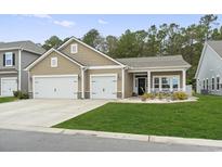 Charming single-Gathering home with a two-car garage, well-manicured lawn, and inviting entrance at 797 Harrison Mill St., Myrtle Beach, SC 29579