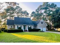 Charming single-Gathering home boasting a manicured lawn and lush landscaping, complete with an attached two-car garage at 8234 Timber Ridge Rd., Conway, SC 29526