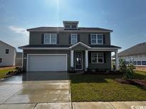 Charming two-story home with a well-manicured lawn and attached two-car garage at 833 Ireland Dr., Longs, SC 29568