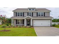 Charming two-story home with gray siding, black shutters, manicured lawn, and an attached two-car garage at 833 Ireland Dr., Longs, SC 29568