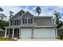 Charming two-story home with gray siding, red shutters, and a two-car garage at 843 Ireland Dr., Longs, SC 29568