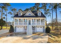 Stunning two-story home with double garages and staircase to a covered balcony overlooking the lake at 904 Easton Ct., Myrtle Beach, SC 29579