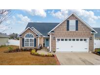 Charming single-Gathering home with a well-manicured front yard and attached two-car garage at 109 Dry Valley Loop, Myrtle Beach, SC 29588