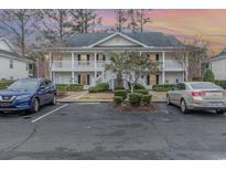 Charming two-story condo with double balconies, manicured landscaping, and convenient parking at 1250 River Oaks Dr. # 16B, Myrtle Beach, SC 29579