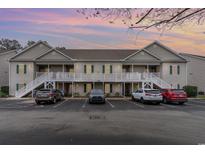 Condominium exterior shows the building with multiple parked cars in front at 130 Lazy Willow Ln. # 204, Myrtle Beach, SC 29588