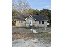 Charming single-story home with vinyl siding and a quaint front porch, surrounded by a chain link fence at 1353 Moss St., Georgetown, SC 29440