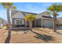 Charming single-story home featuring a two-car garage, complemented by drought-resistant landscaping and palm trees at 1685 Sapphire Dr., Longs, SC 29568