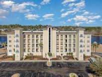 Stunning exterior view of a condominium featuring multiple balconies and ample parking space at 265 Venice Way # 1-201, Myrtle Beach, SC 29577