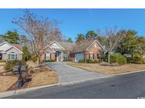 Charming brick home with well-manicured lawn and welcoming driveway at 286 Willow Bay Dr., Murrells Inlet, SC 29576