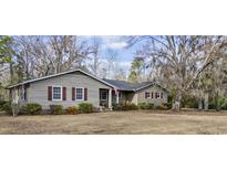 Charming ranch-style home with wood siding, red shutters, and a well-manicured front yard at 3281 Long Avenue Ext., Conway, SC 29526