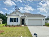 Charming single-story home featuring white siding, blue shutters, and a two-car attached garage at 395 Clear Lake Dr., Conway, SC 29526
