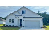 Charming single-Gathering home with white siding, a two-car garage, and well-manicured lawn at 415 Clear Lake Dr., Conway, SC 29526